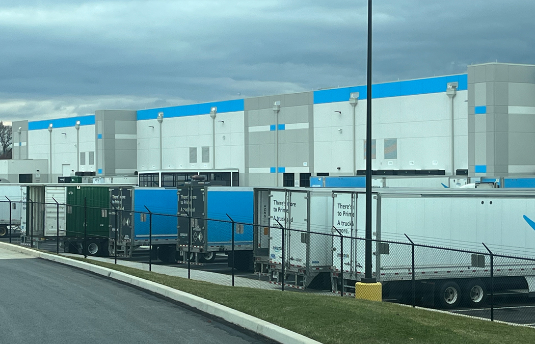 permanent fence protects an Amazon warehouse