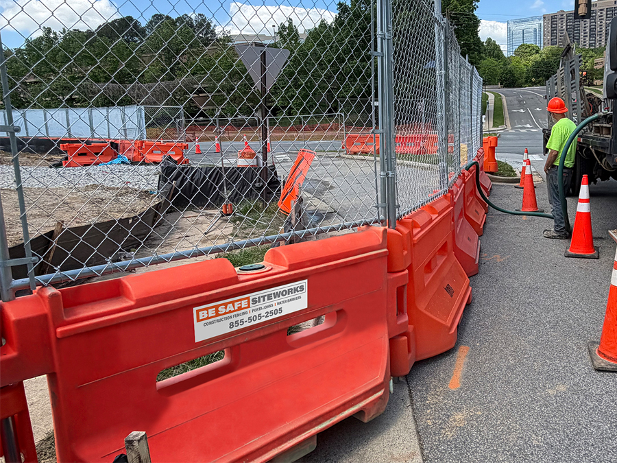 water-filler barriers with fence  on top surround construction site