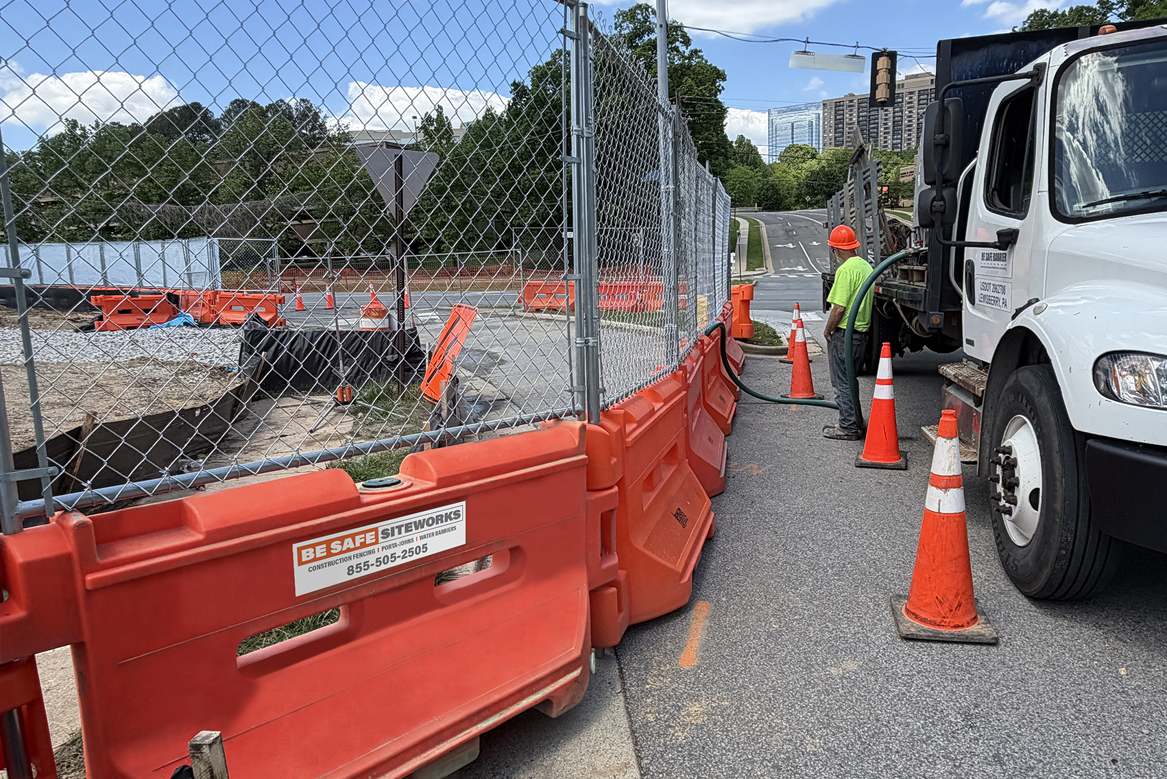 Water filled barriers with fencing on top safely protects site perimeter